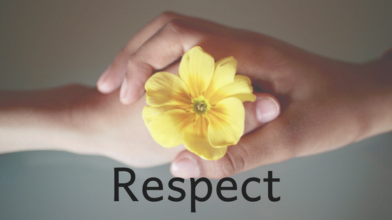 hands holding a yellow flower