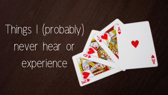 four playing cards on brown table