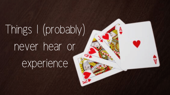 four playing cards on brown table