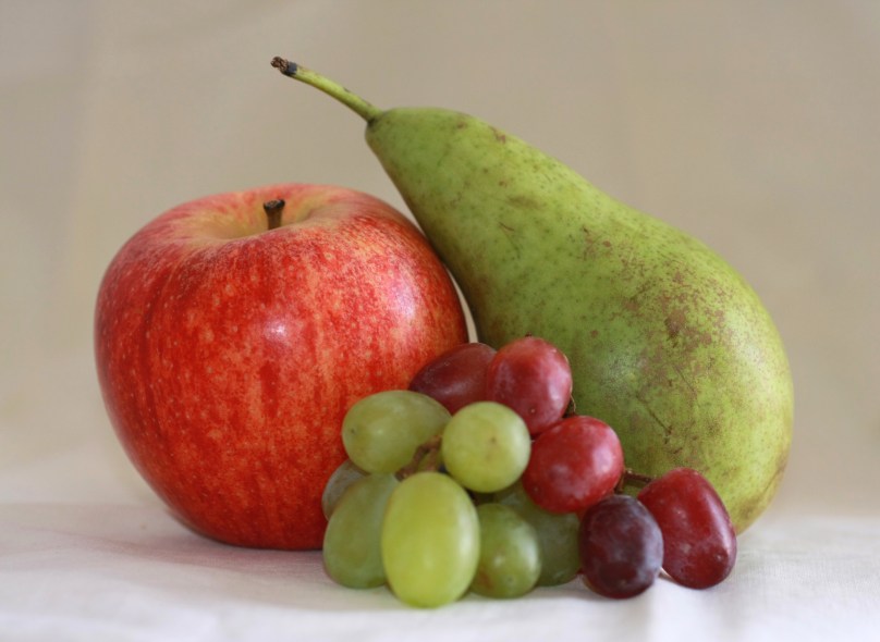 apple, green and red grapes and a pear